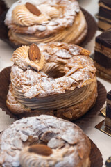 Freshly baked stuffed sweet Paris-Brest pastries in traditinal French bakery in small village in Provence