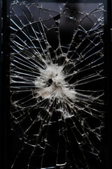 Obraz premium Close-Up of a Shattered Smartphone Screen with Cracks Radiating from Impact Point