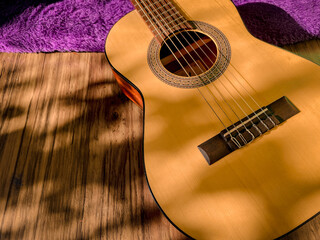 Obraz premium Classical guitar with natural sunlight background. Copy Space. Music Instruments design.