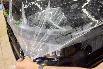Workshop process of applying protective film to safeguard car headlights from scratches and damage