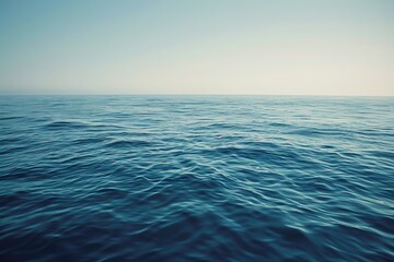 Fototapeta premium Serene ocean vista at dawn, capturing the calm blue waters under a soft gradient sky, ideal for tranquil and nature themes.
