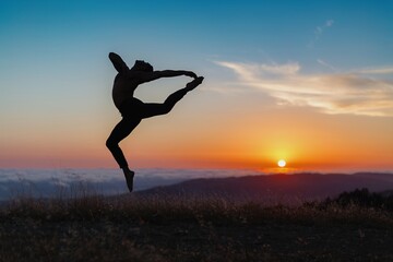 Silhouette of male ballet dancer jumping and doing a majestic dance move in nature, Behind him are heavenly clouds and the sun is setting.
