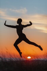 Silhouette of male ballet dancer jumping and doing a majestic dance move in nature, Behind him are heavenly clouds and the sun is setting.