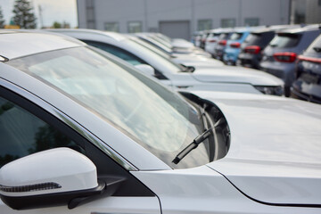 Car Sales and Loan Industry Concept. Row of Brand New Vehicles in Stock.