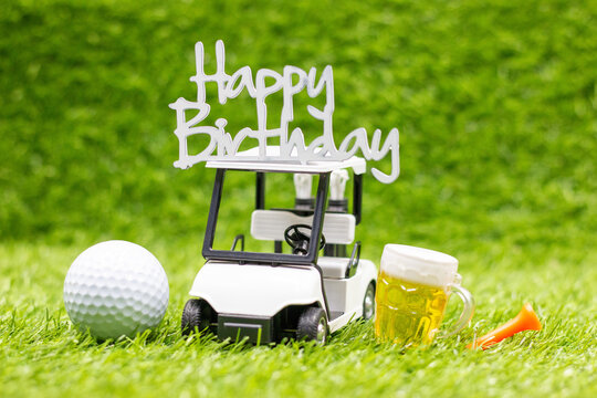 Golf birthday theme on green grass with golf ball and tee celebration concept