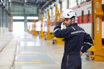 Back view technician or worker looking to something at construction train station