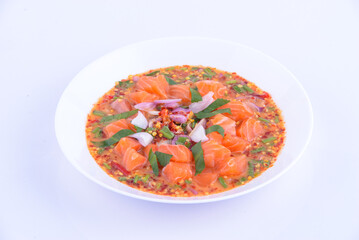 Thai spicy salmon salad on the white background.