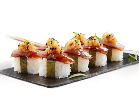 Bite sized pieces of brown rice sushi topped with smoked salmon