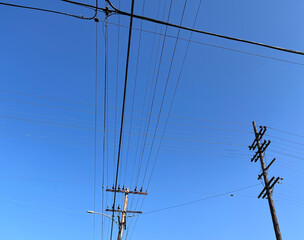 Electricity pylon under blue sky