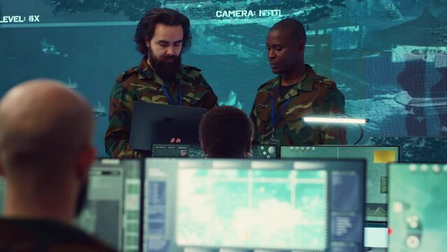 Crew captain and general briefing the troops in military headquarters command center, operating with a big screen to follow CCTV reconnaissance system. Soldiers collecting data. Camera A.