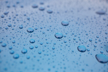 A serene image of water droplets on a smooth surface, capturing a tranquil and peaceful scene