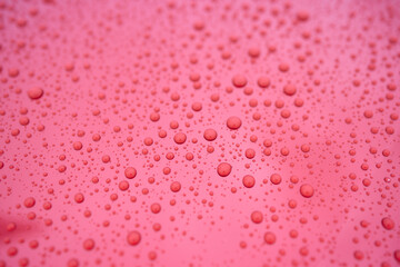 A serene image of water droplets on a smooth surface, capturing a tranquil and peaceful scene