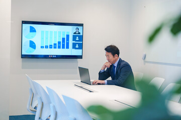 会議室でリモート会議をするビジネスマン