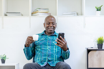 Senior man staring at his smartphone in confusion and using