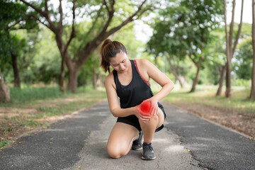 A woman is hurting her knee after running. Health problem concept, osteoarthritis problem. Running...