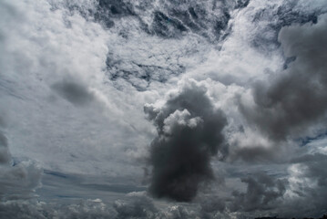Dark rain cloud dramatic sky summer tropical thunder storm sky and fluffy black darkness cloud nearly raining cloudscape. Nimbus raincloud skyline climate background. Dark gray sky cloudy environment