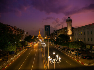 Fototapeta premium Streets of downtown Yangon on the road to Sule Pagoda time lapse with traffic jam and modern city