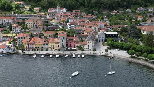 Aerial View Of A Picturesque Waterfront Town With Colorful Buildings Bordering Pella Lake. Orbit Motion Shot