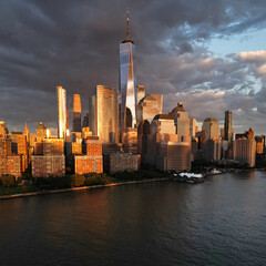 NYC aerial view, New York City Skyline with dramatic sky. Panoramic drone view on Manhattan in NY. Sunset in NYC. New York City Midtown skyline view at dusk with dark clouds.