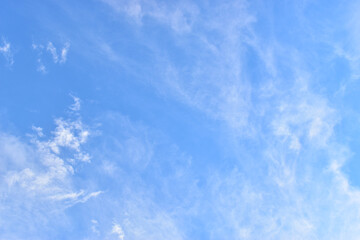 beautiful blue sky and white fluffy group of clouds with sunrise in the morning, natural background
