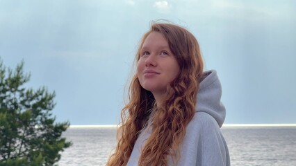 Young woman enjoying weather on sea, beach, breath deep fresh air