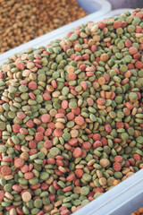 stack of dried cat food display for sale at local market 