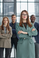 Fototapeta premium Portrait of a confident young businesswoman standing with her arms crossed in an office