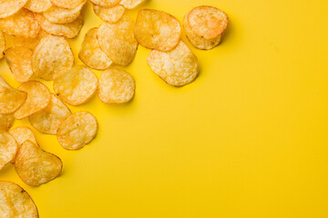 Crispy Potato Chips on Yellow Background. Top view.