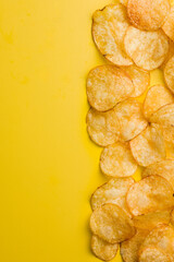 Crispy Potato Chips on Yellow Background. Top view.
