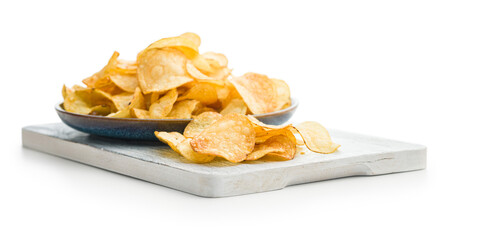 Close Up of Crispy Potato Chips on cutting board  isolated on White Background