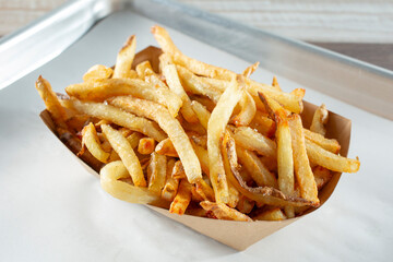 A closeup view of a tray of French fries.