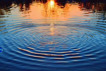 A ripple reflects the suns light on a lakes surface, A serene lake with ripples reflecting the colors of a setting sun