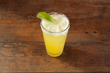 A view of a yellow colored margarita beverage.
