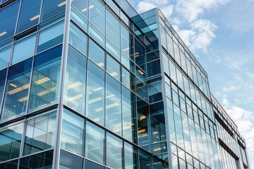 Obraz premium A very tall, sleek office building with a multitude of windows reflecting the surrounding cityscape, A sleek and modern office building with reflective glass windows