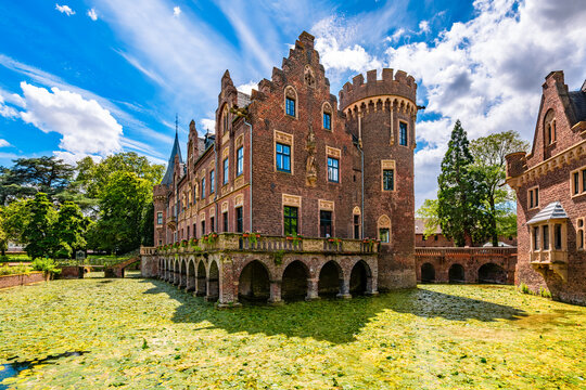Red brick moated castle &ldquo;Schloss Paf&shy;fen&shy;dorf&ldquo; in Bergheim near Cologne (Germany) with its his&shy;tor&shy;ic&shy;al am&shy;bi&shy;en&shy;ce and splendid parks is a popular tourist attraction, monument and idyllic sight. 