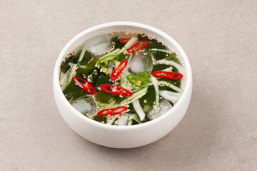 A food made by cutting cucumbers into small pieces, pickling them in salt or soy sauce, adding them to cold soup, and adding green onions, vinegar, sugar, and red pepper powder.
