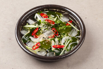 A food made by cutting cucumbers into small pieces, pickling them in salt or soy sauce, adding them to cold soup, and adding green onions, vinegar, sugar, and red pepper powder.
