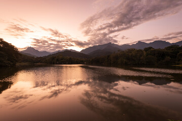 Beautiful lake with water reflections and mountains on the back