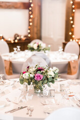 Elegant wedding reception table with floral centerpiece