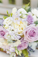 Bouquet featuring lavender and white roses with delicate greenery