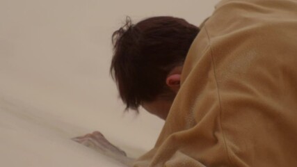 desperate asiatic male wearing a robe trying to hiking on hands the sand dunes looking for help and water