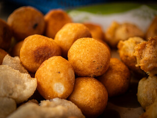 Jemblem. Indonesian traditional food is sweet and savory. It's made of grated cassava with melted brown sugar as filling. The food is deep fried. Selective focus