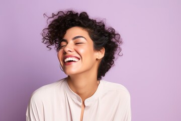 The happy Middle Eastern woman, 30 years old, winking on a pastel lavender background