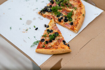 Pizza slices on cardboard packaging. Fast food.