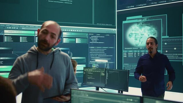 Governmental cyber defense team using advanced technology to secure information, cyber operations in high tech monitoring center. Working on data protection and threat detection. Camera B.