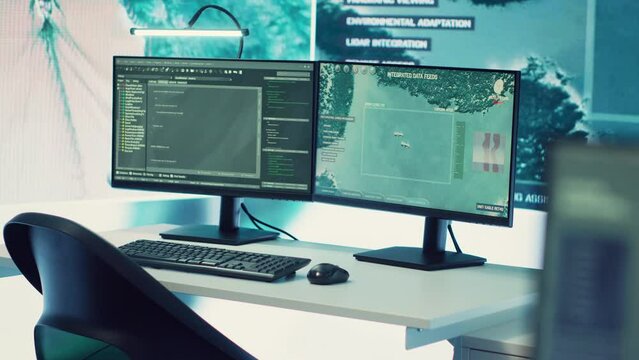 Federal anti terrorism operation room equipped with a big screen and radar surveillance footage on satellite cctv system used for reconnaissance. Empty military command center.