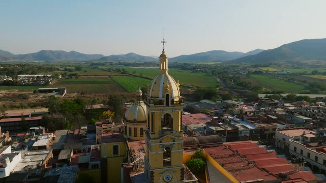 Beautiful architectural details on the main bell tower of the catholic church Our Lady of the Sanctuary in Tamazula, Mexico,. Orbit drone aerial