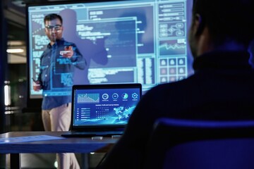 Talking about project. Male business trainer is against projector with data, teaching people