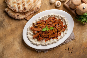 Sliced Steak or Chicken Mushroom Sliced meat grill and cooked with mushroom, served with mutabal.