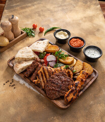 Assorted mix grills with tikka boti seekh kabab of chicken, beef, lamb, mutton bbq platter served in dish isolated on table top view of arabian food